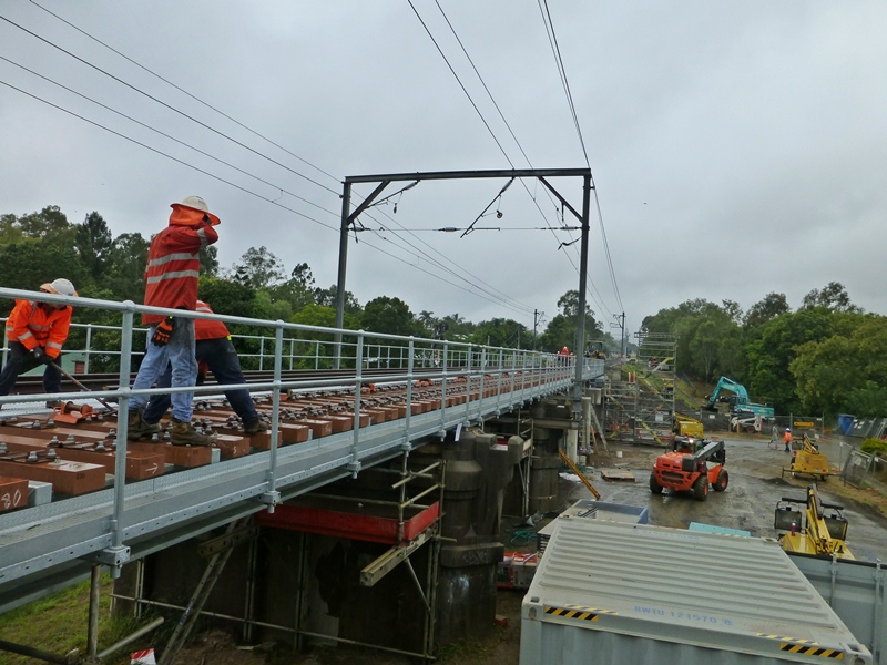 A view of the installed bridges showing the new steel spans with walkways and handrails for the railway maintenance personnel