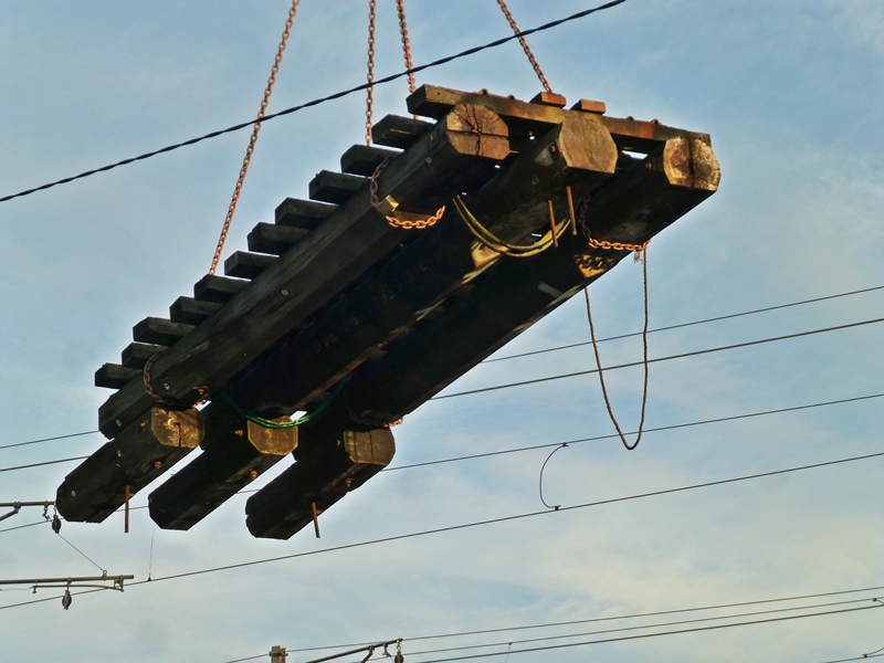 The lifted timber decks had to be hoisted over and avoiding the power wires, which were moved aside, to enable the decks to be lifted vertically and lowered onto trucks in the road below for removal.