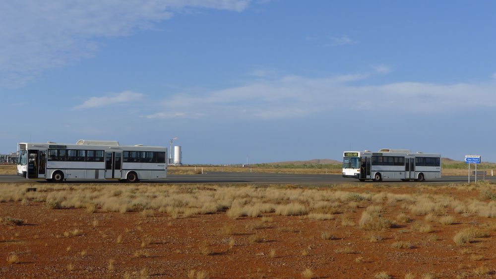 Diesel buses 679 and 686 pose outside the gas plant