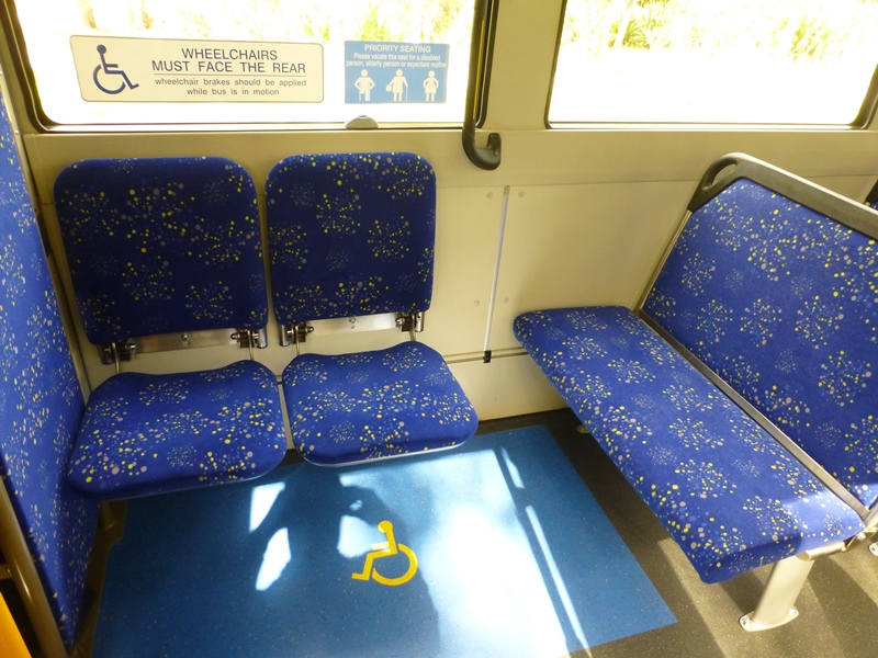 Space for one wheel chair. The single seats and the bench seat fold up. A light weight ramp is stored to the left of the driver.